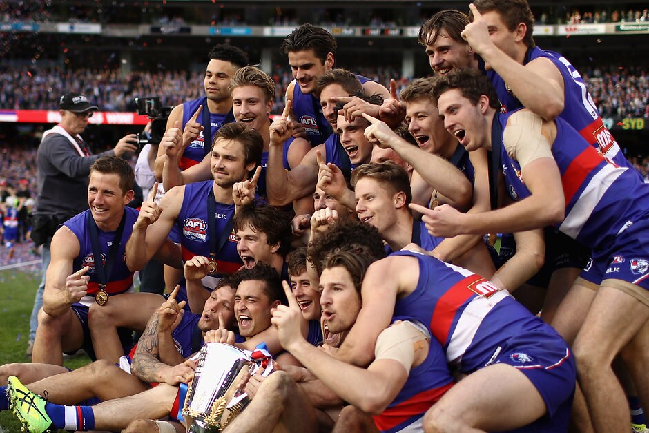 AFL 2016 Toyota AFL Grand Final - Sydney v Western Bulldogs MELBOURNE, AUSTRALIA - OCTOBER 01: Bulldogs players pose with the Premiership Cup after winning the 2016 Toyota AFL Grand Final match between the Sydney Swans and the Western Bulldogs at the Melbourne Cricket Ground on October 01, 2016 in Melbourne, Australia. (Photo by Cameron Spencer/AFL Media)